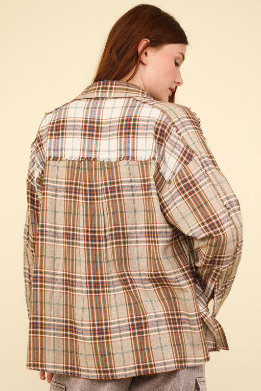 Woman wearing a contrast plaid taupe shirt with raw edge details, showcasing a casual-chic style and oversized fit.