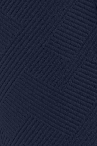 Close-up of navy textured pattern fabric detail from a long sleeve top and drawstring shorts set made of polyester and spandex.