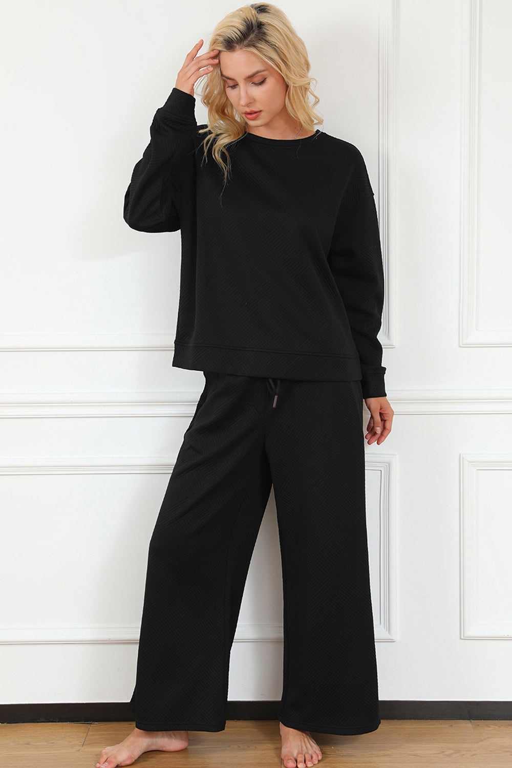 Textured long sleeve top and drawstring pants set in black, featuring a slightly stretchy fabric for comfort and style.