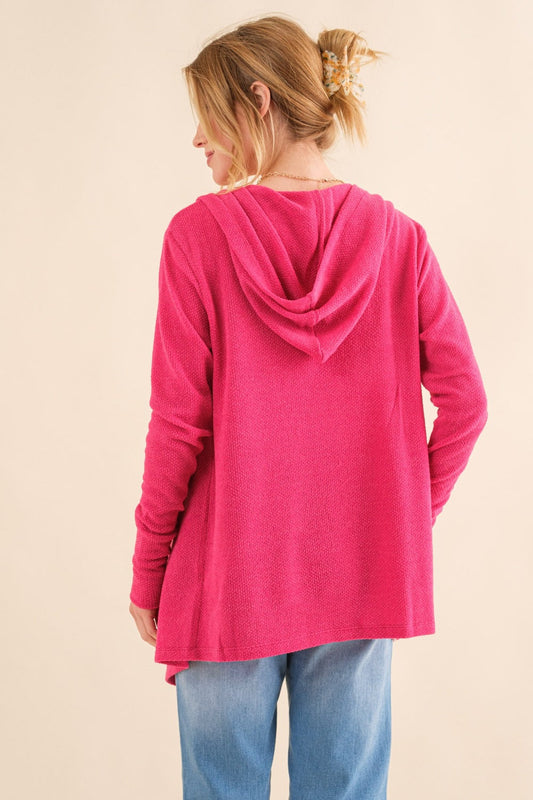 Woman wearing pink thermal hooded open-front cardigan with pockets, made of polyester and spandex, showcasing the back view.