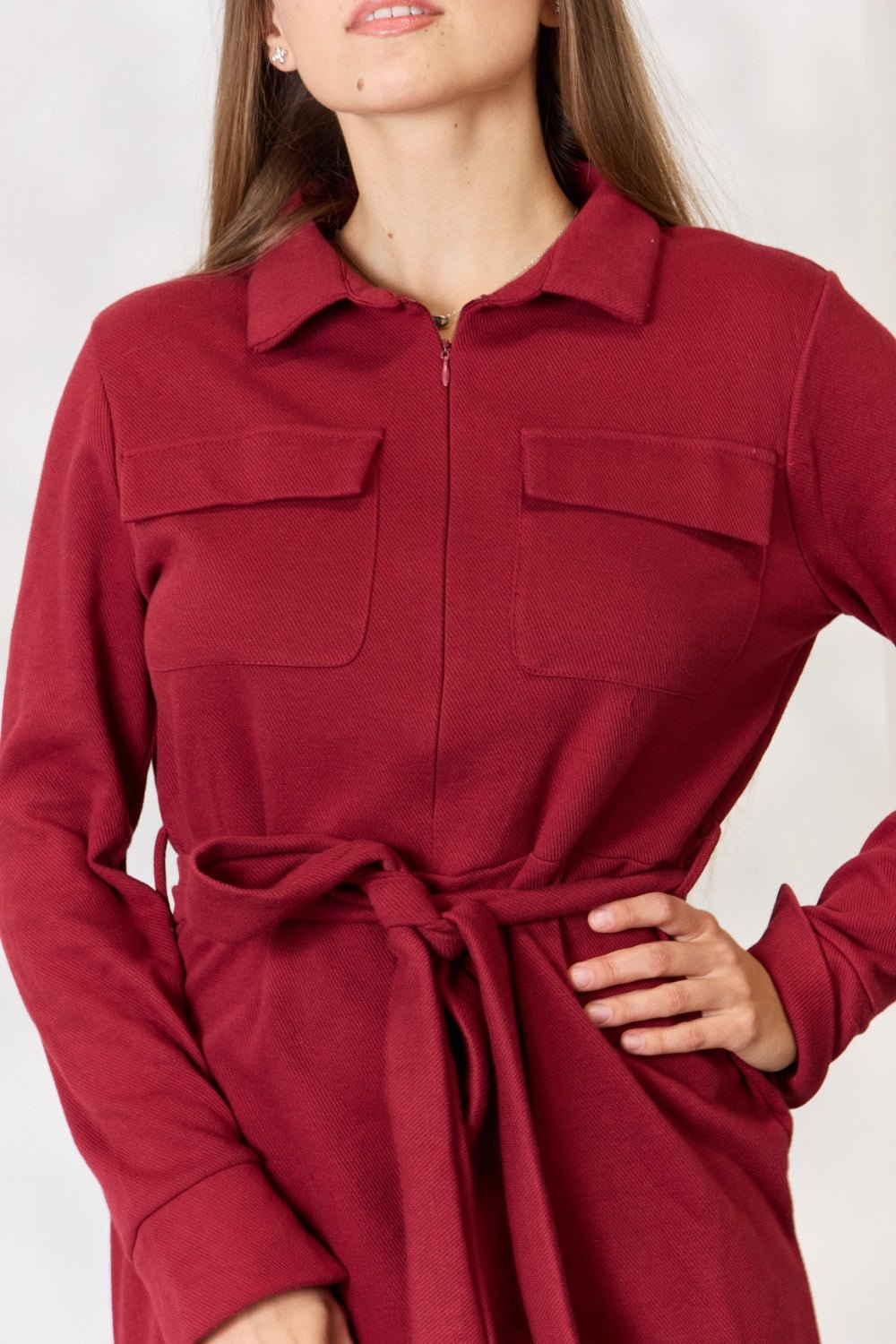 Red tie front half zip long sleeve shirt dress with pockets, featuring a collared neckline and adjustable waist tie.