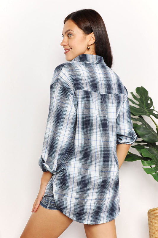 Woman wearing plaid dropped shoulder shirt, showcasing sleek fit and versatile style for casual and dressy looks.