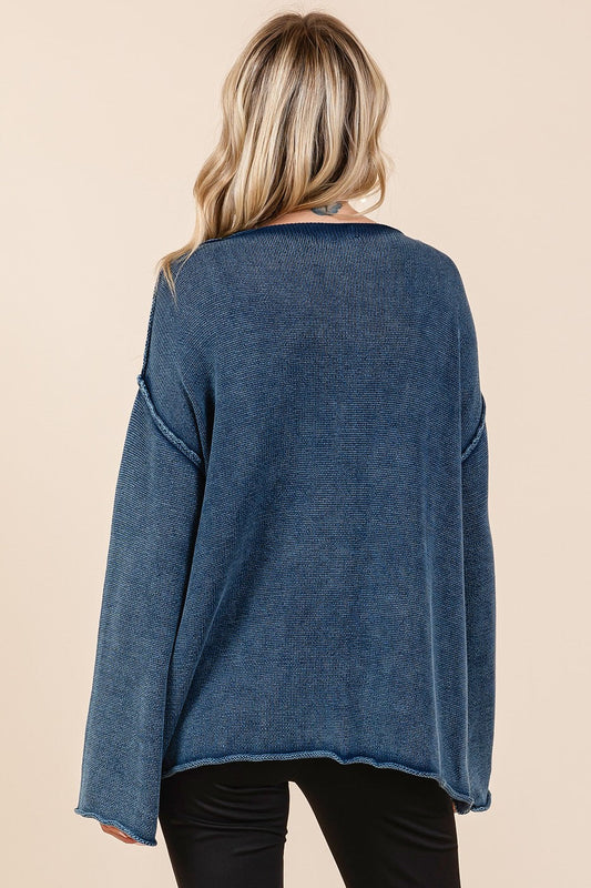 Back view of a blue Mittoshop Mineral Wash Patch Pocket Cut Edge Sweater with exposed seams and casual style.