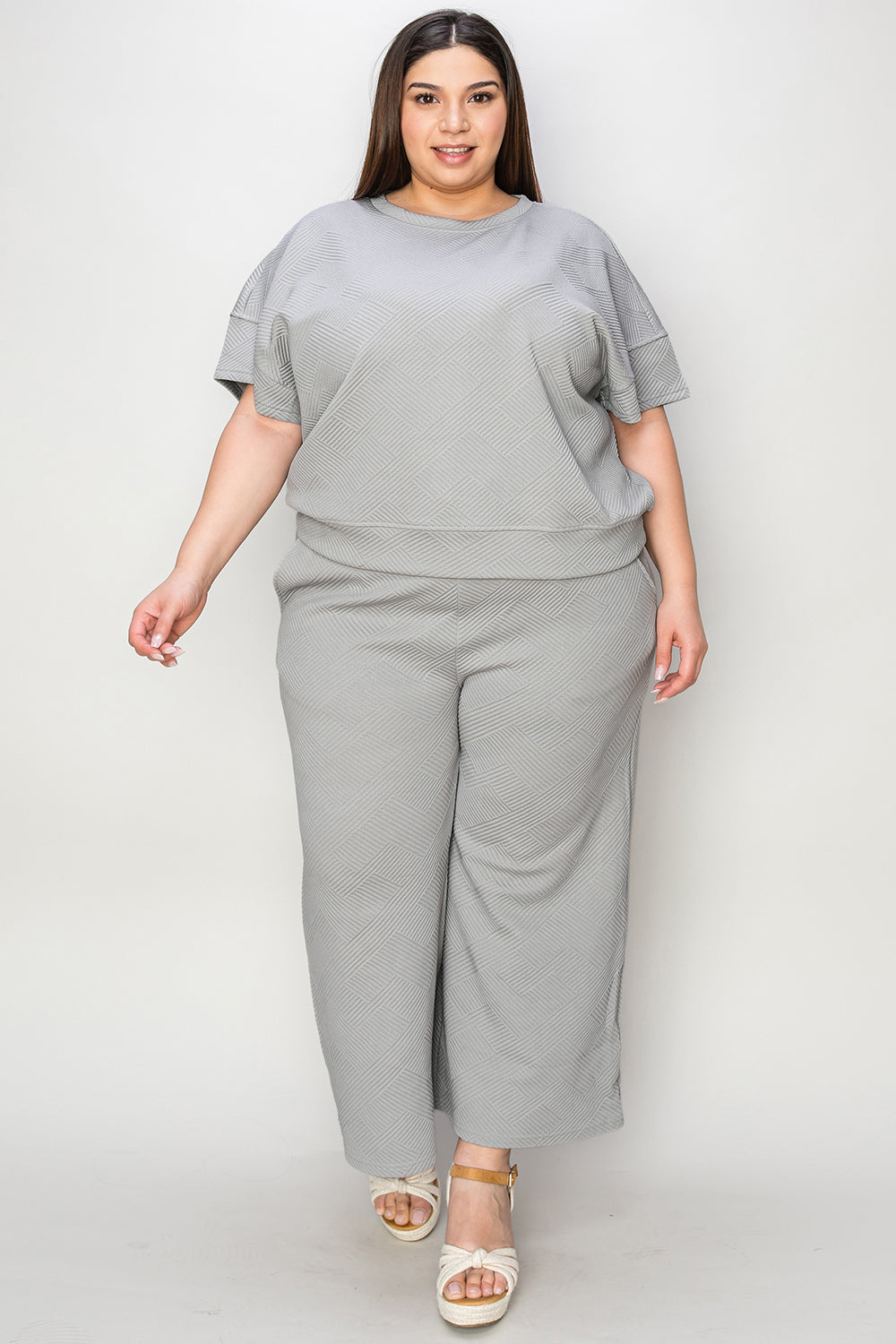 Woman wearing a gray two-piece texture short sleeve top and pants set with drawstring, made from slightly stretchy polyester and spandex.