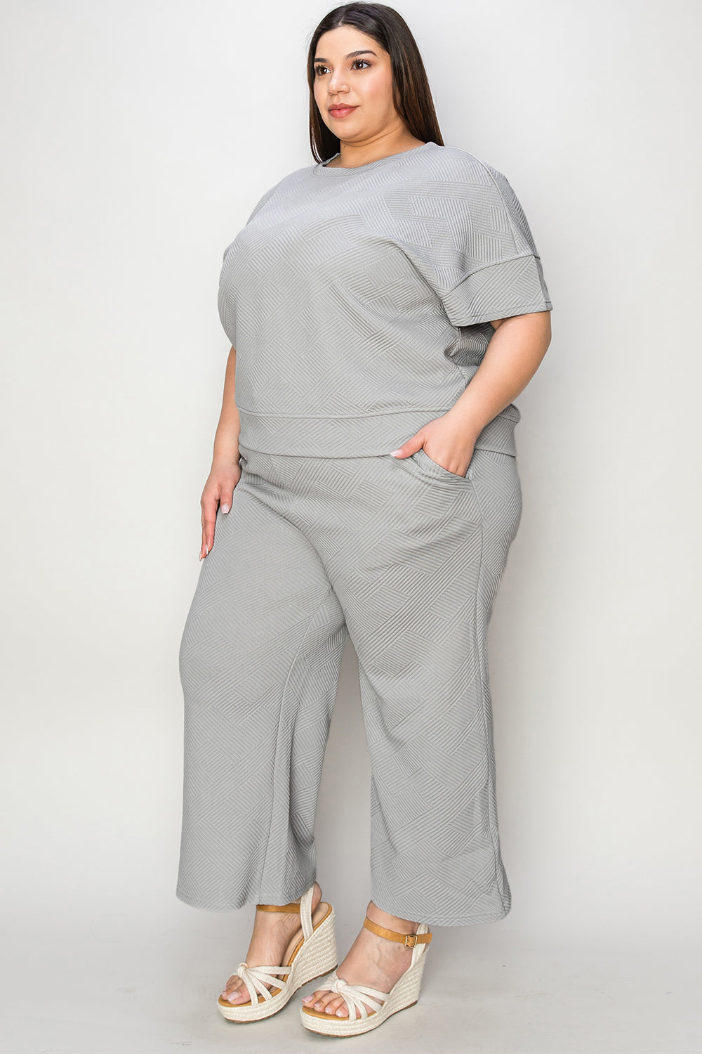 Woman wearing gray texture short sleeve top and pants set with drawstring, slightly stretchy fabric, 95% polyester, 5% spandex.