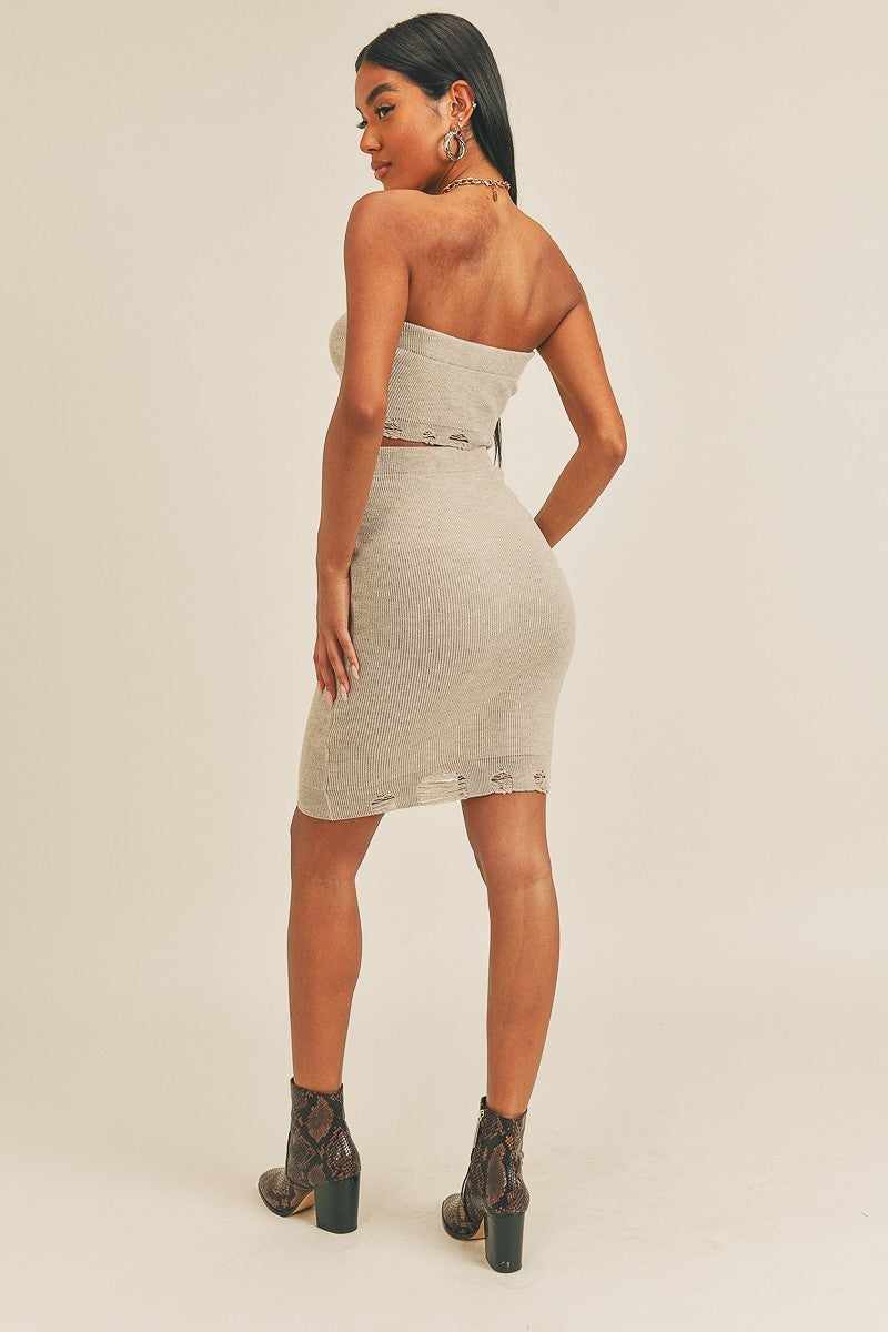 Trendy two-piece set featuring tube top and high-rise pencil skirt in gray, crafted with polyester and spandex, shown from the back.