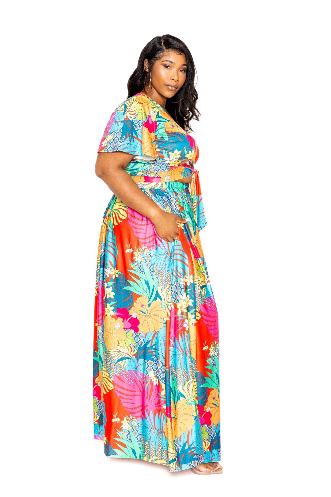 Tropical floral plus size maxi skirt and top set in vibrant colors, worn by a woman standing sideways.