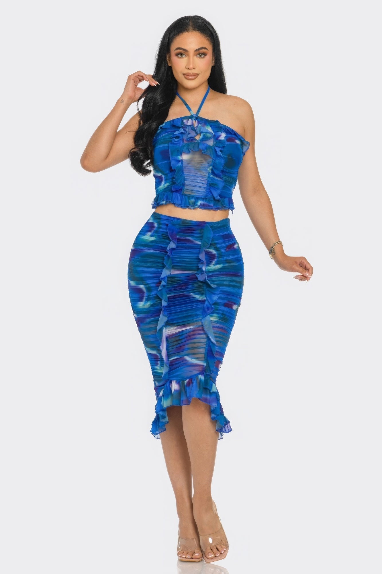 Woman wearing blue ruffle halter skirt set with tropical print and playful design, perfect for beach or summer occasions.