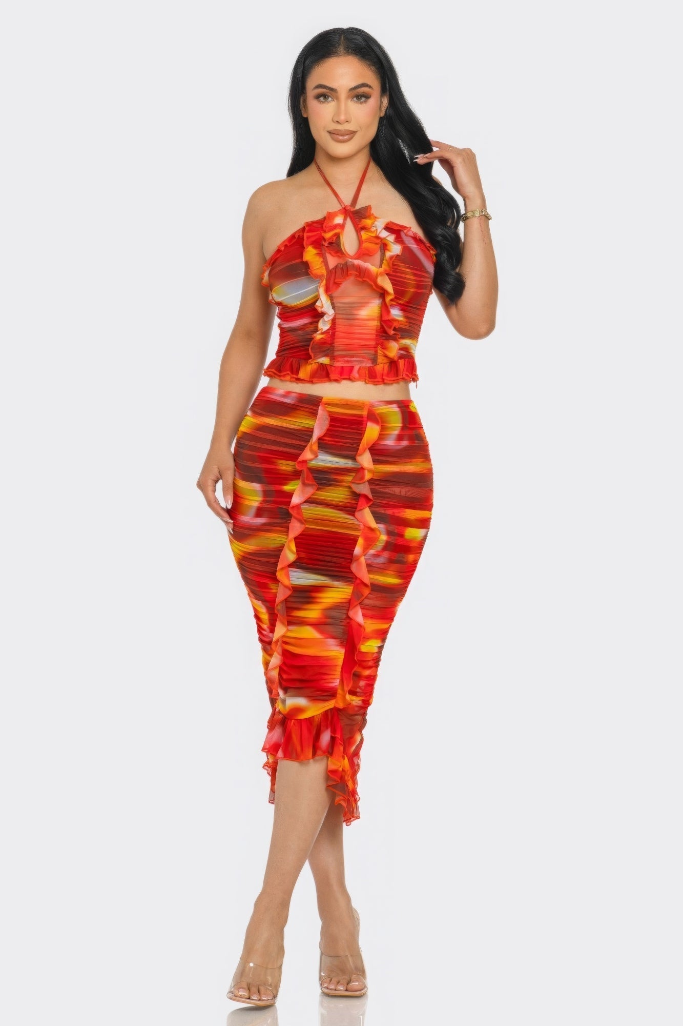 Woman wearing Tropical Waters Print Mesh Ruffle Halter Skirt Set in vibrant orange with ruffle trim, perfect for summer occasions.