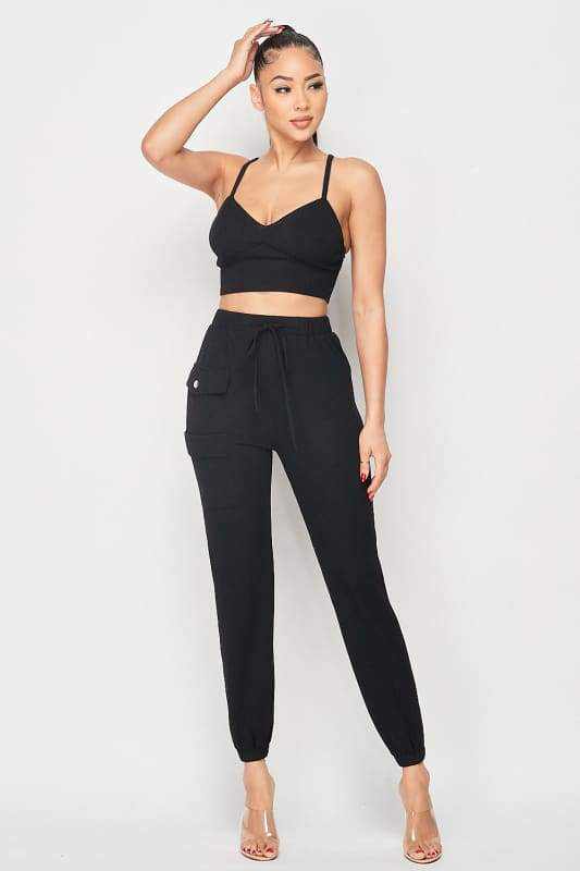 Woman wearing black ribbed cropped cami and joggers set, chic and comfy two-piece outfit, perfect for casual wear.