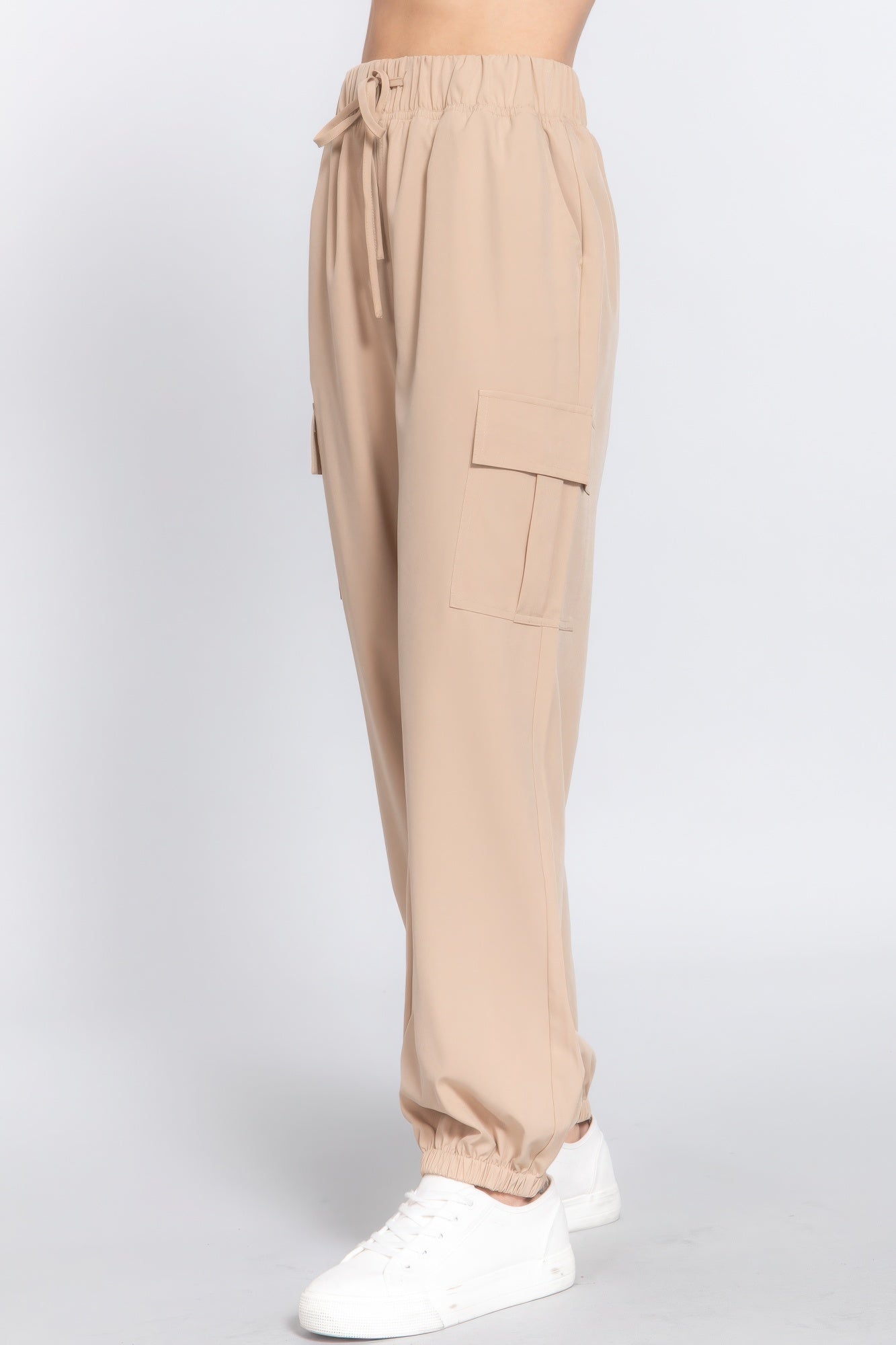 Beige lightweight stretch woven cargo jogger pants with trendy pockets, perfect for versatile casual wear and modern comfort.