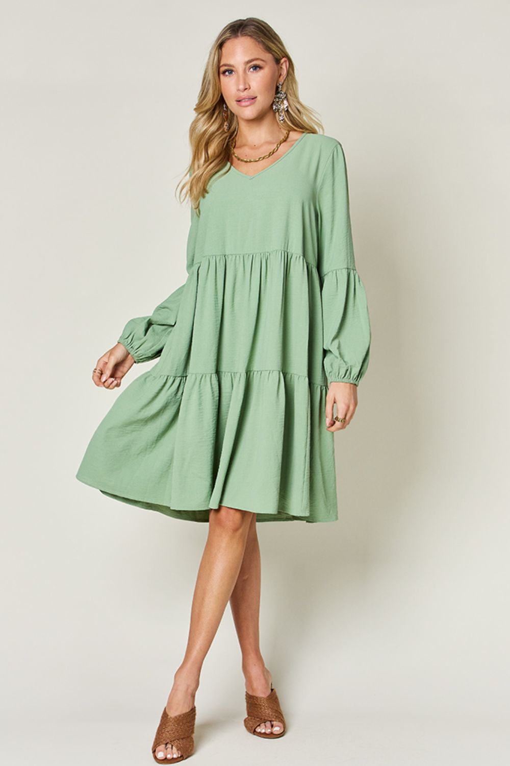 V-neck balloon sleeve tiered dress with pockets in green, featuring a ruffled design and high stretch yarn for comfort and style.