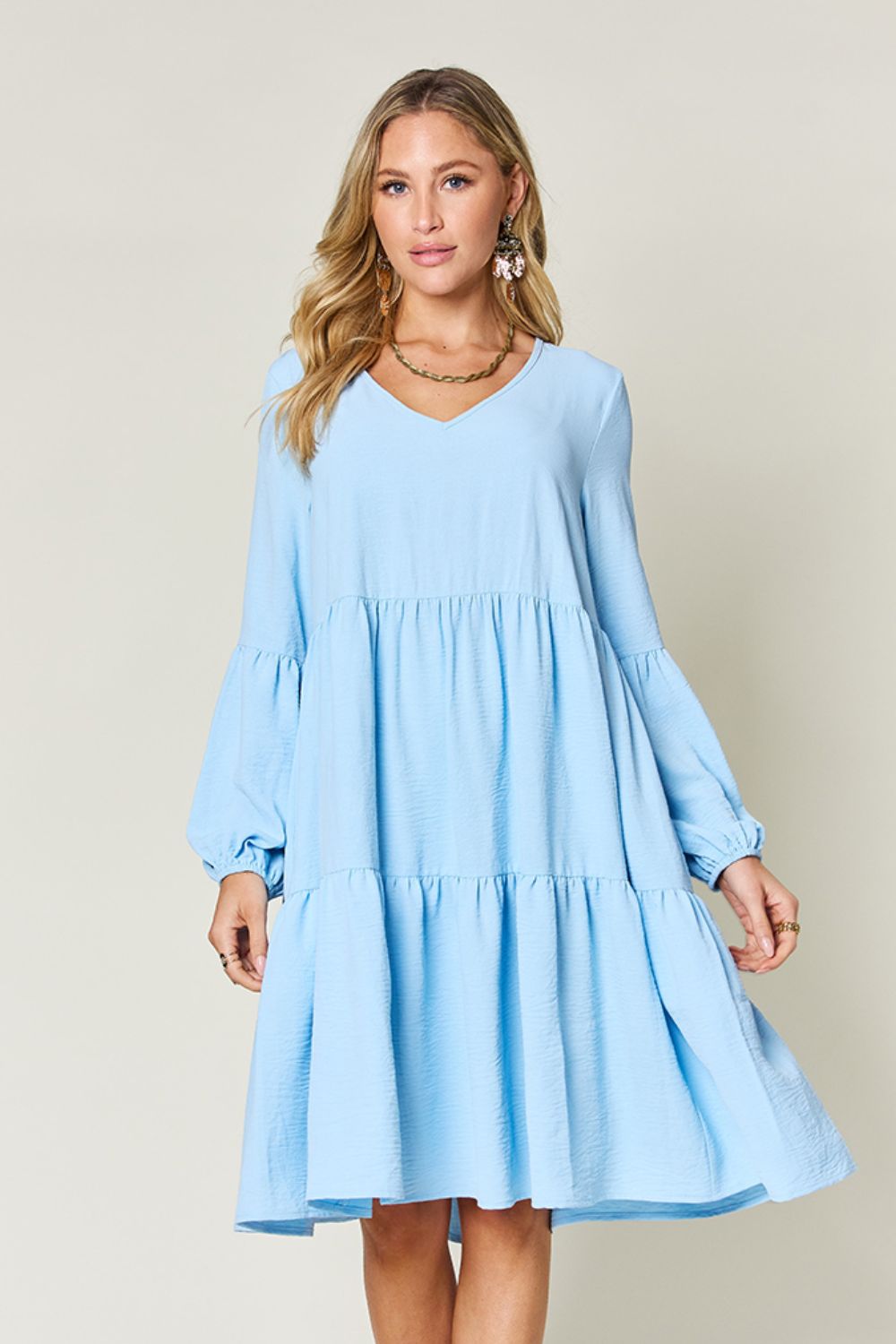 V-Neck Balloon Sleeve Tiered Dress with Pockets in light blue, featuring ruffled hem and opaque fabric.