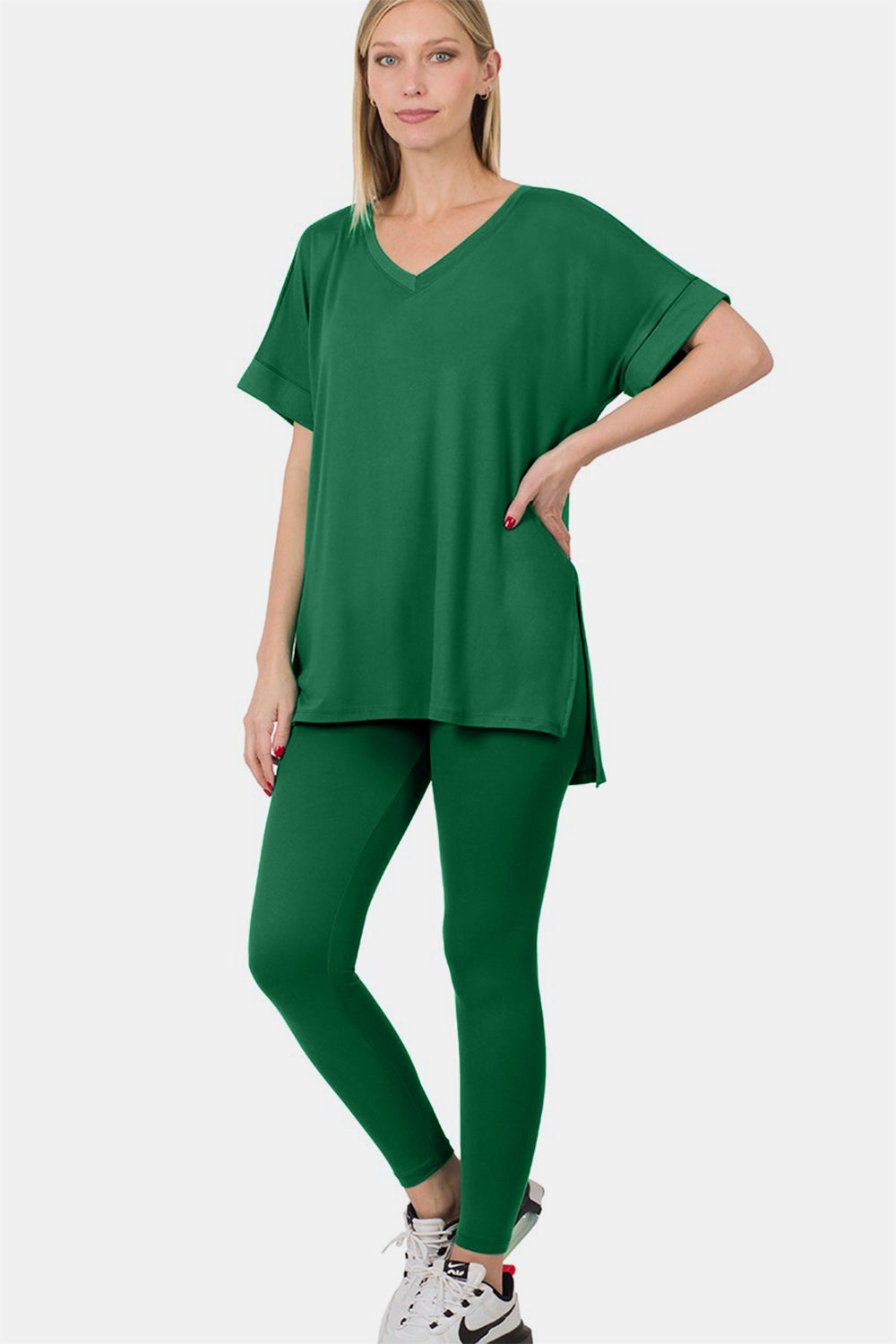 Woman wearing green V-neck rolled short sleeve T-shirt and leggings lounge set with a chic, minimalist style.