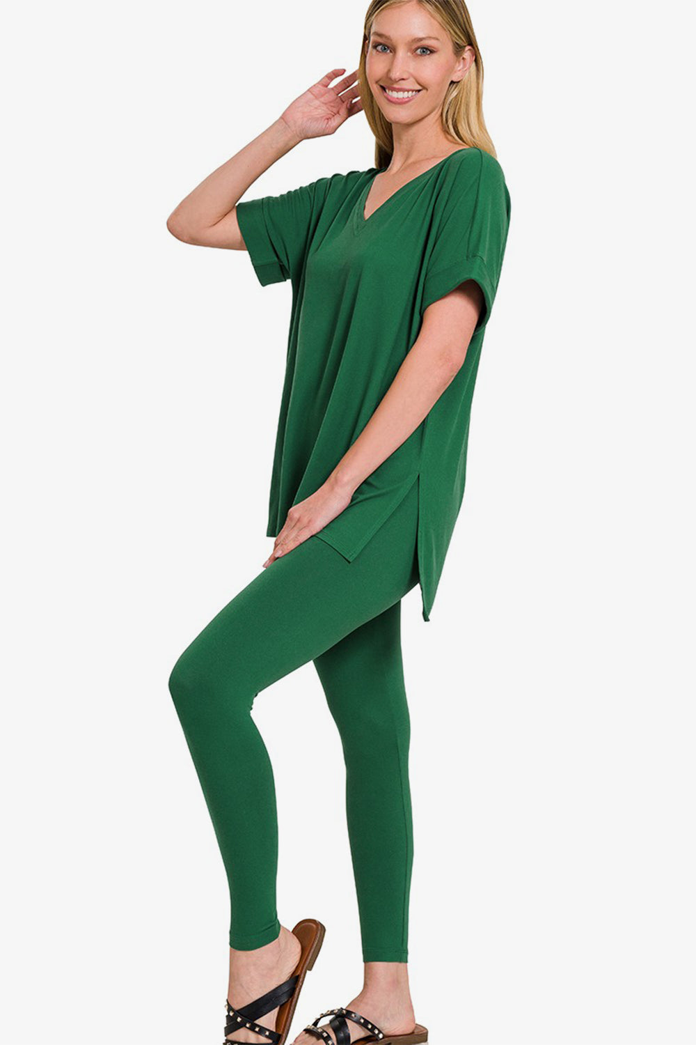 Woman wearing a green V-neck rolled short sleeve T-shirt and leggings lounge set, showcasing a comfortable and chic style.