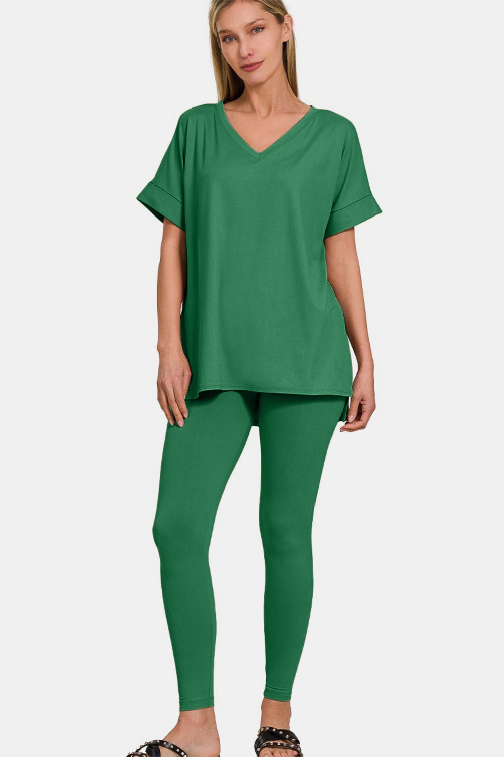 Woman wearing green V-neck rolled short sleeve T-shirt and leggings lounge set, showcasing comfort and style.