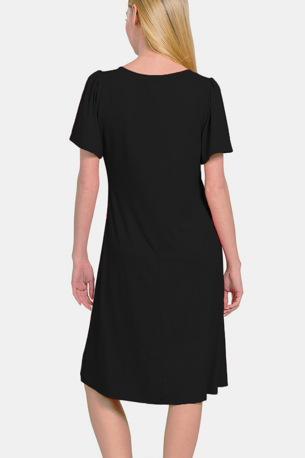 Woman wearing black V-neck short sleeve dress with a flattering fit viewed from the back.