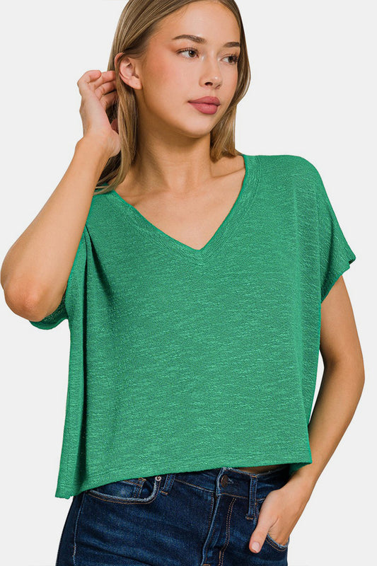 Woman wearing green V-neck short sleeve T-shirt made of polyester, rayon, and spandex, casual and comfortable style.