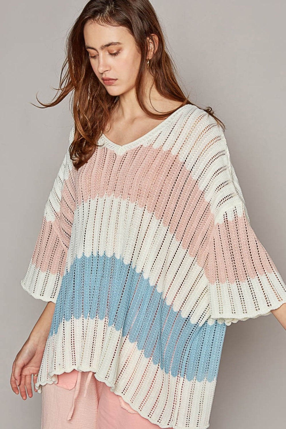 Woman wearing V-neck short sleeve stripe weave sweater with openwork design, 100% acrylic material in pastel colors.