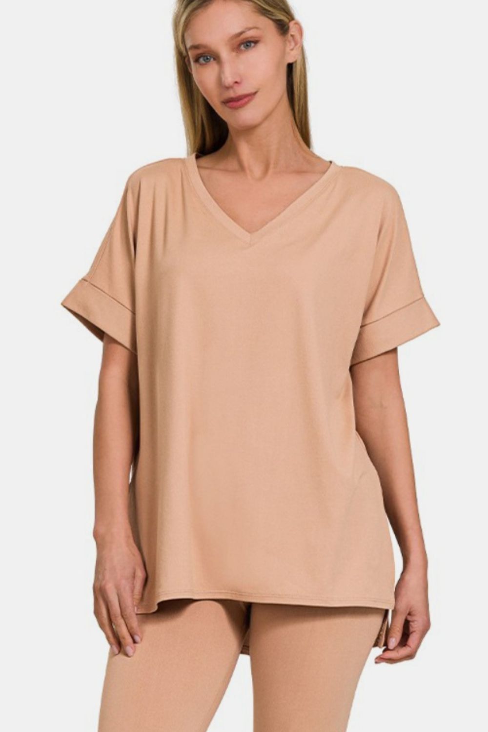 Woman wearing chic V-neck rolled short sleeve T-shirt and leggings lounge set, showcasing effortless, versatile style in beige.