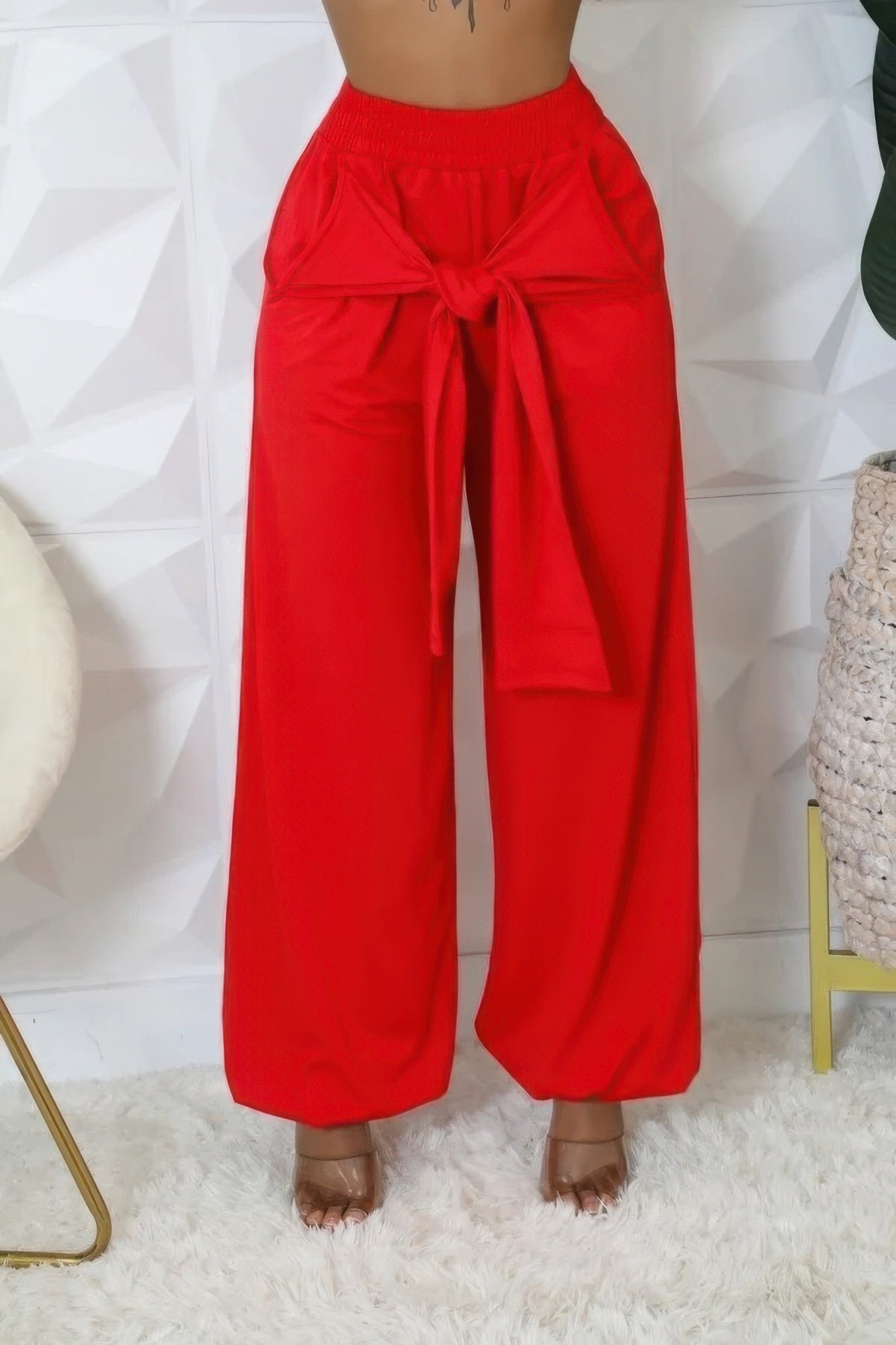 Red high-waisted stretch pants with bow detail, displaying a stylish and comfortable fit suitable for various body types.