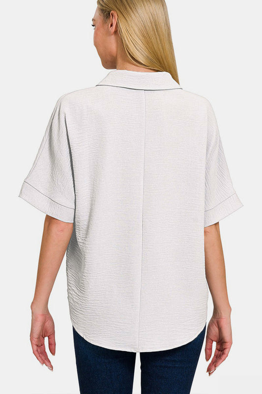 Woman wearing a white texture collared neck short sleeve top, showcasing back design and comfortable fit.