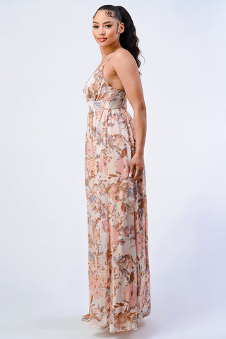 Woman wearing vintage floral smocked chiffon fit and flare maxi dress in blush, side view.