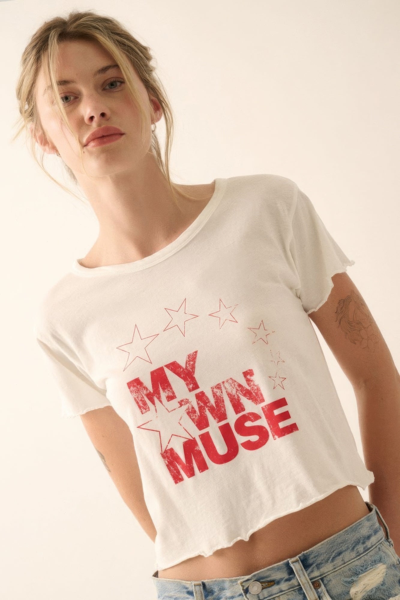 Vintage wash cropped tee with "My Own Muse" graphic and star print, worn by a model, perfect for casual and festival looks.