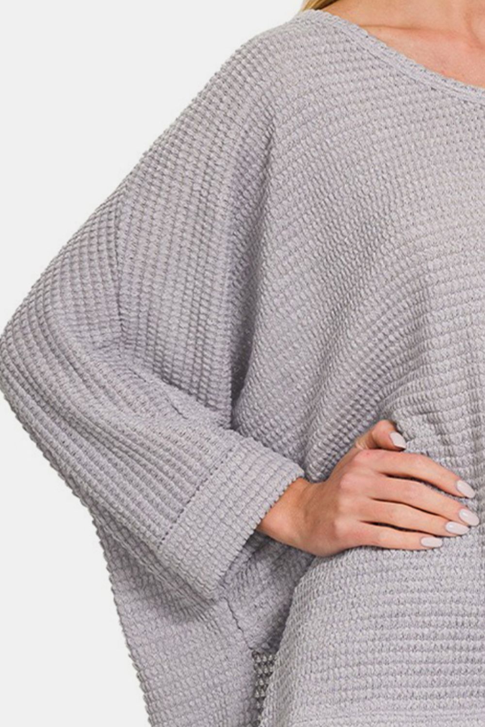 Waffle knit V-neck long sleeve top with high-low design, slight stretch, made of polyester, rayon, and spandex blend.