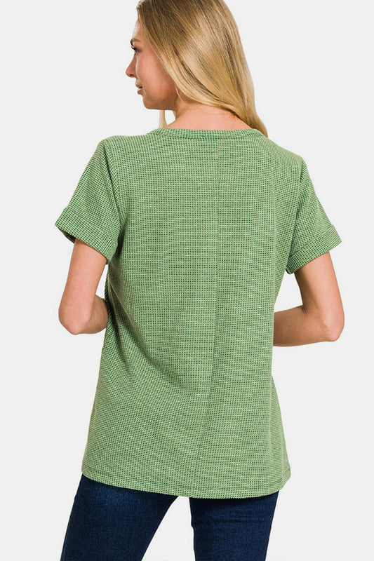 Woman wearing green waffle-knit notched short sleeve t-shirt, back view.