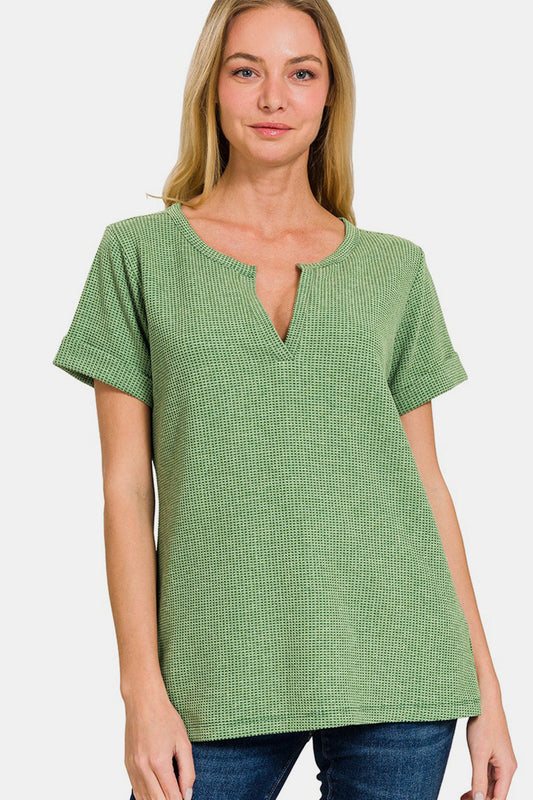 Woman wearing green waffle-knit notched short sleeve t-shirt, featuring a basic style with a slightly stretchy fabric.