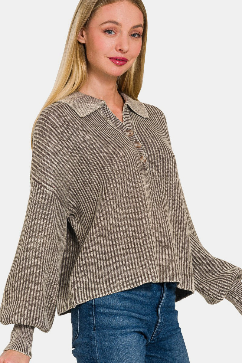 Woman wearing a washed half button long sleeve sweater made of 100% cotton, featuring a slightly stretchy material.