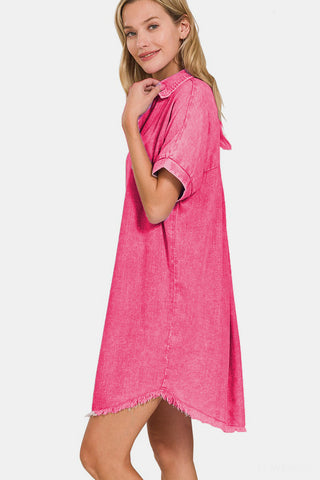 Woman wearing pink washed linen V-neck raw hem dress with moderate stretch, featuring short sleeves and casual style.