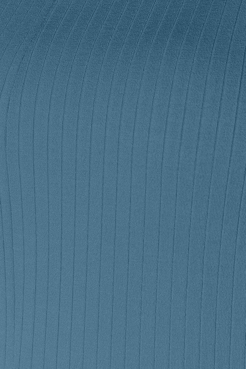 Close-up of blue ribbed fabric texture with vertical lines.