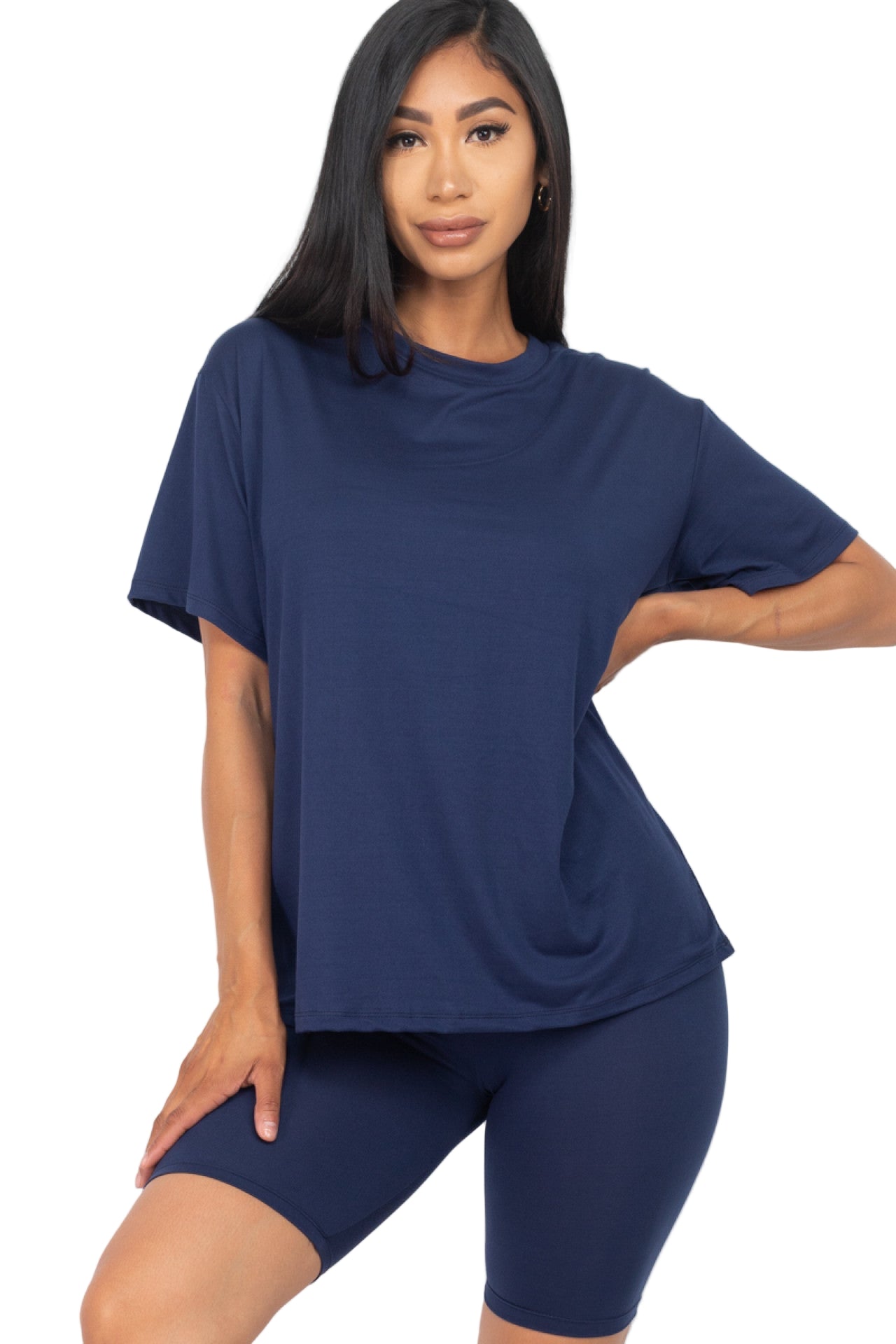 Woman wearing loose fit top and biker shorts set in navy, showcasing soft, stretchy fabric with elastic waist for casual and workout wear.