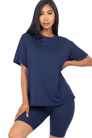 Woman wearing loose fit top and biker shorts set in navy, showcasing soft, stretchy fabric with elastic waist for casual and workout wear.