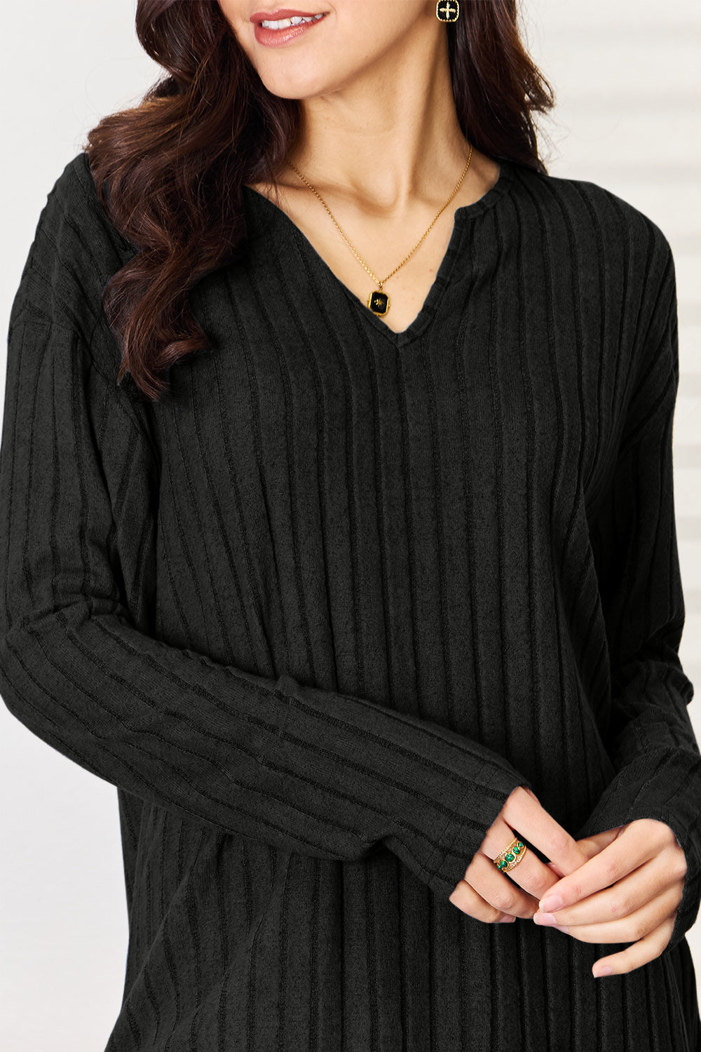 Women's notched long sleeve ribbed top in black, modern casual fashion.