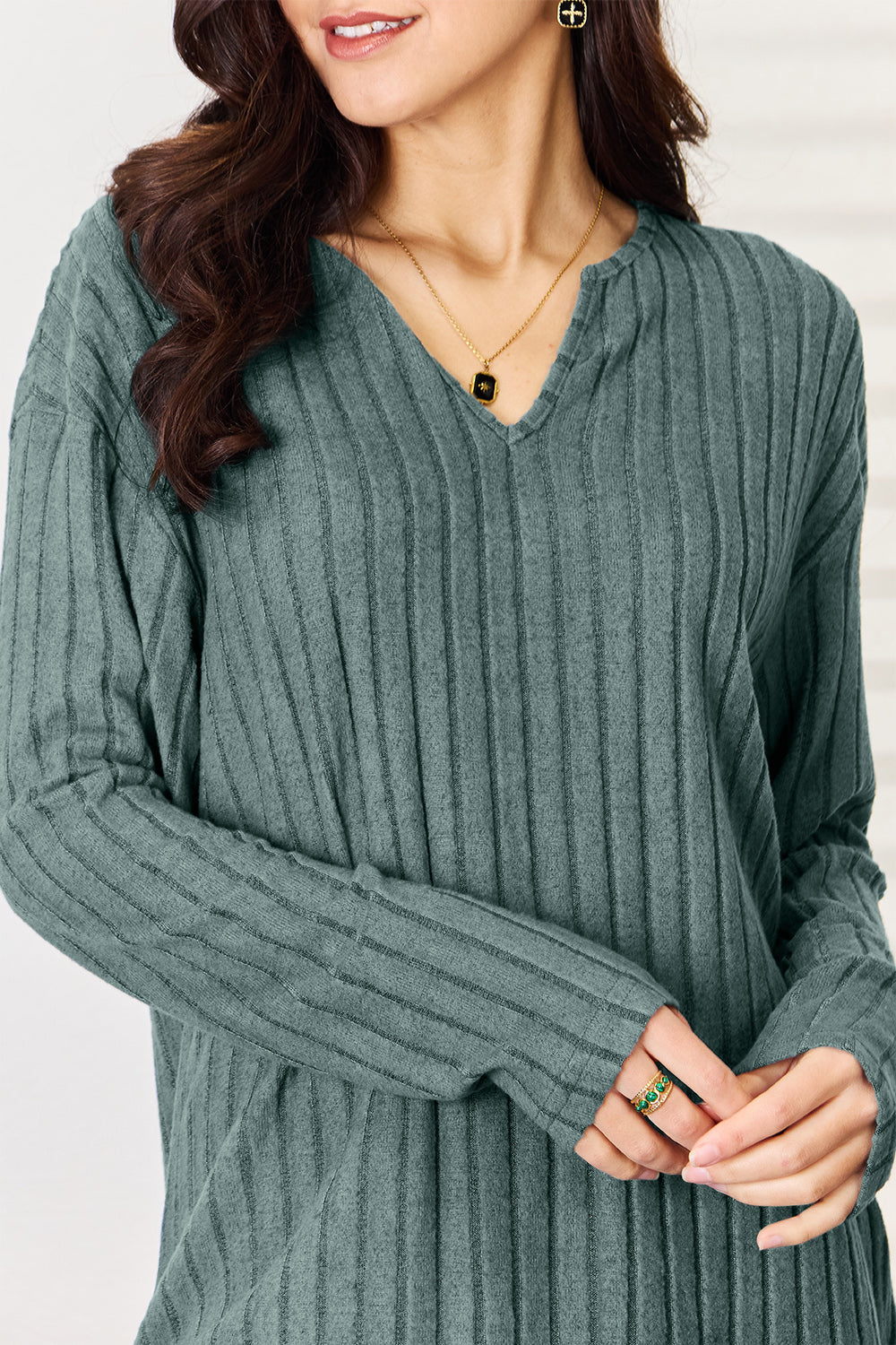 Women's ribbed notched long sleeve top in soft green, featuring stylish texture and modern design for a chic casual look.