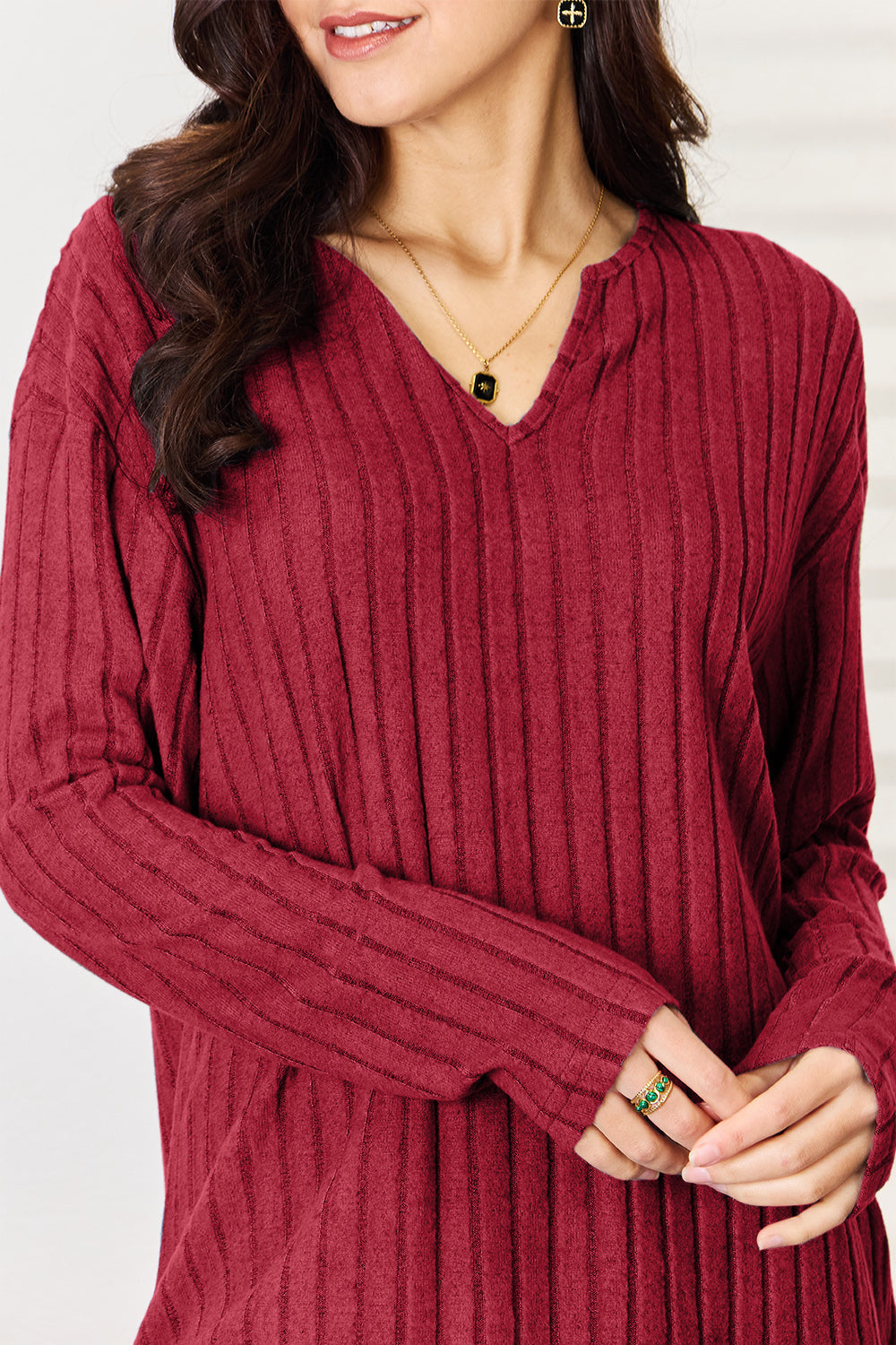 Women's ribbed notched long sleeve top in red, casual chic style.