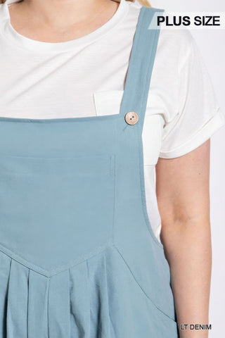 Plus size pintuck detail overall with side pockets in light denim, featuring wooden button accents and comfortable fit.