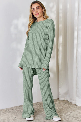 Woman wearing green ribbed high-low top and wide-leg pants set, slightly stretchy fabric, casual fashion style.
