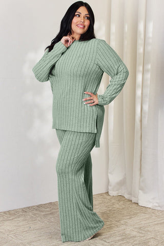 Plus-size model in green ribbed high-low top and wide-leg pants set, stylish two-piece outfit.