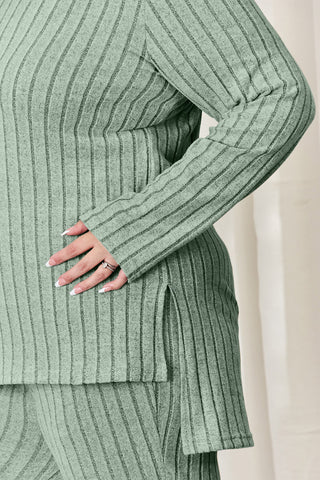 Ribbed high-low top and wide leg pants set in green, featuring a side slit and long sleeves, made of polyester and elastane mix.