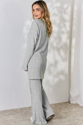 Woman wearing gray ribbed high-low top and wide-leg pants set, back view.