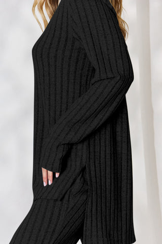 Ribbed high-low black top and wide leg pants set, slightly stretchy polyester-elastane, stylish and cozy two-piece outfit.