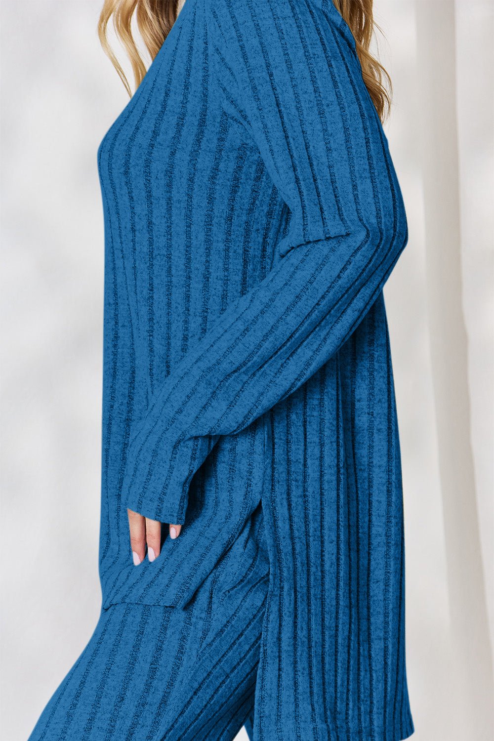 Blue ribbed high-low top and wide leg pants set, two-piece outfit, slightly stretchy polyester blend, stylish and comfortable design.