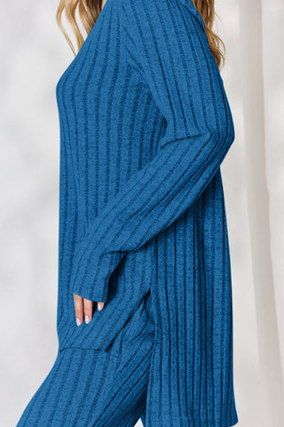 Blue ribbed high-low top and wide leg pants set, two-piece outfit, slightly stretchy polyester blend, stylish and comfortable design.