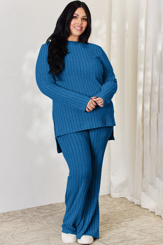Woman wearing blue ribbed high-low top and wide leg pants set, plus-size fashion, stylish loungewear outfit.