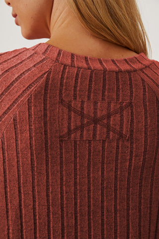 Back view of Basic Bae ribbed thumbhole sleeve t-shirt in red, highlighting textured design and stitching detail.