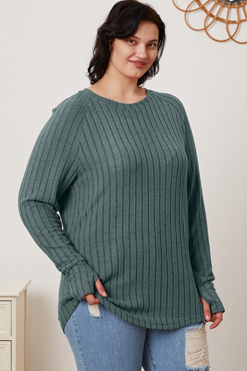 Woman wearing a Basic Bae ribbed thumbhole sleeve t-shirt in teal, paired with ripped jeans.